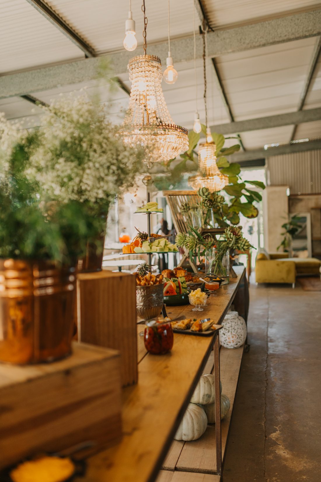 A harvest table beneath crystal chandeliers in the Fountain Room