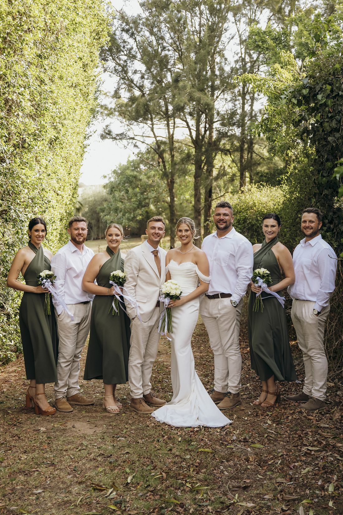 A bridal party gathered in the garden