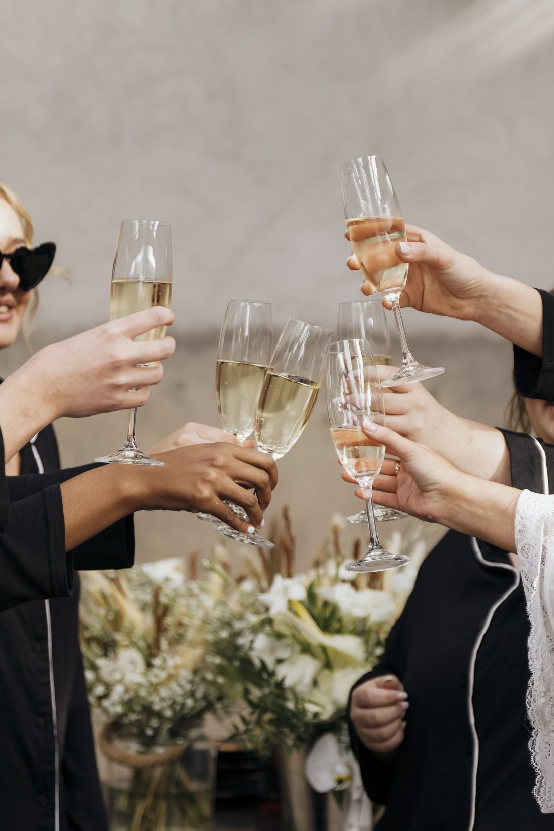 Glasses of bubbly raised together on the morning of the wedding